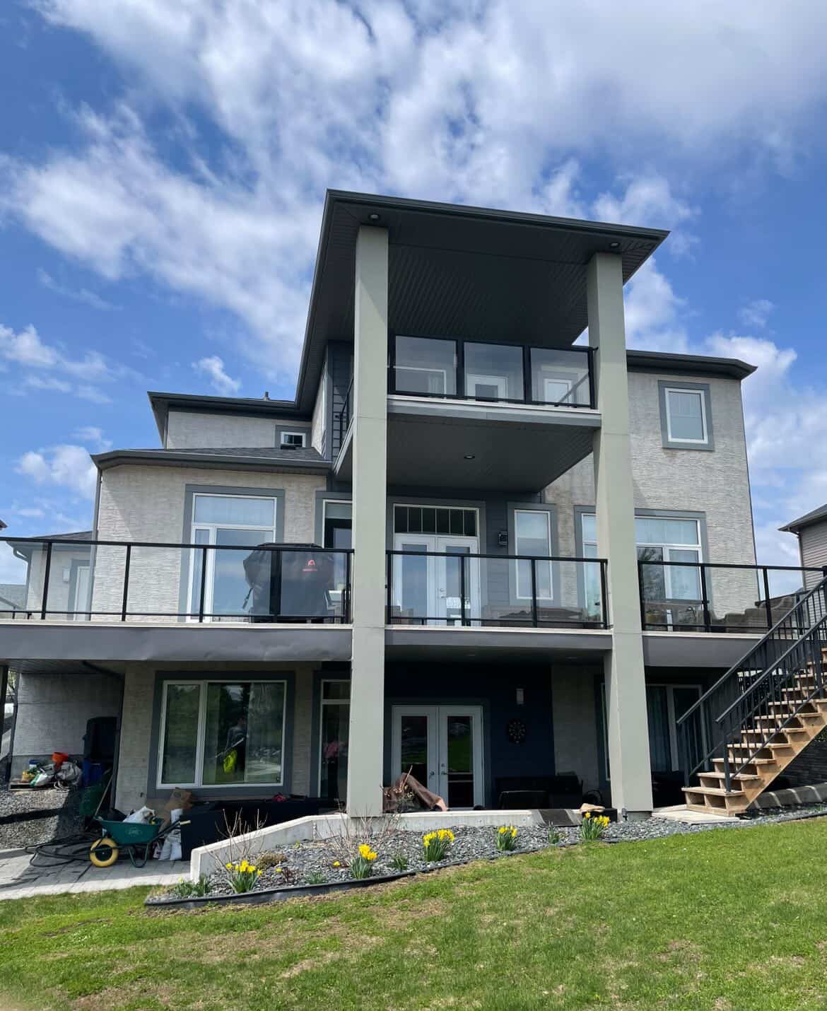 Modern two-story Winnipeg home exterior with sparkling clean windows and glass balcony railings